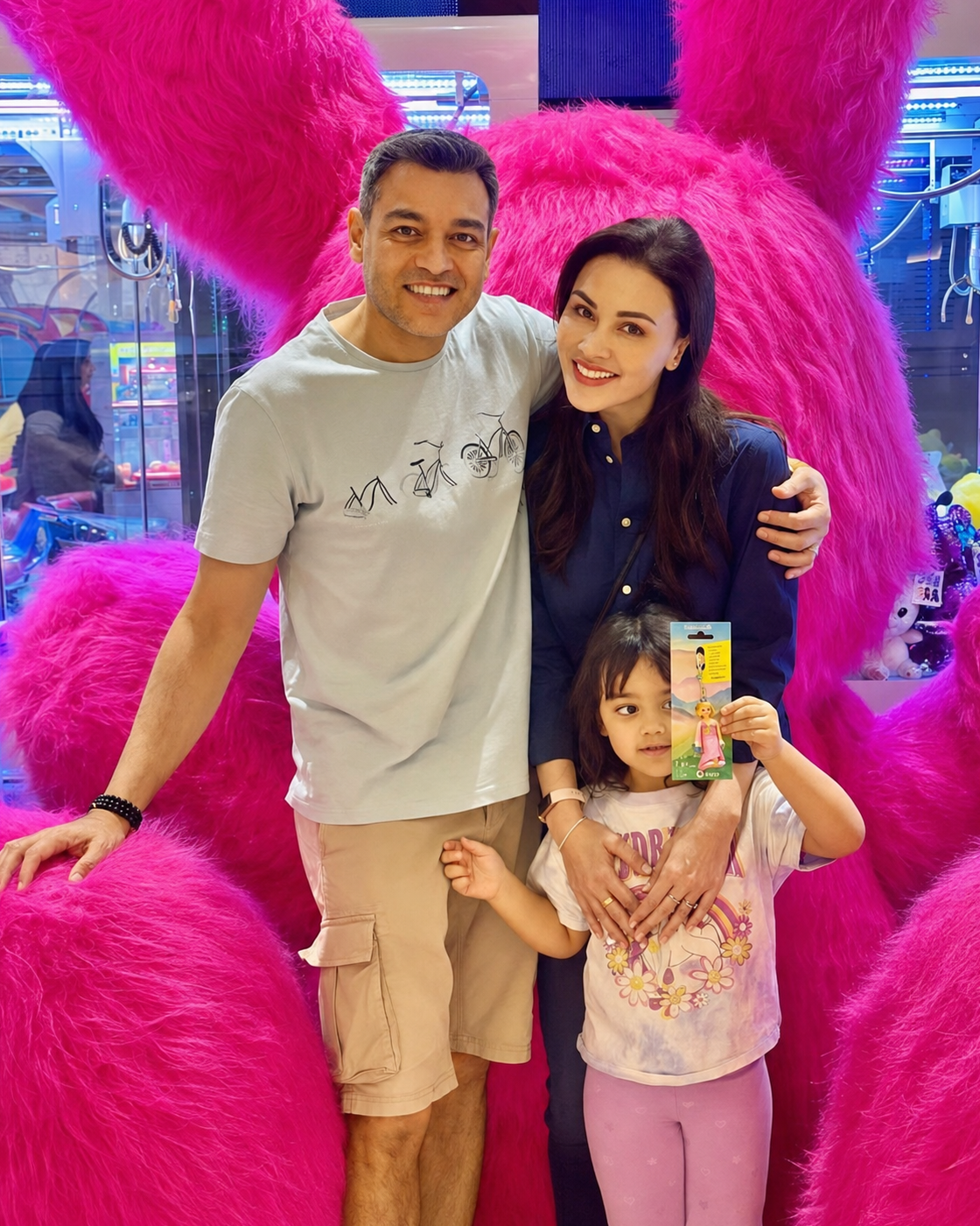 A family posing with a colorful MetaPark attraction