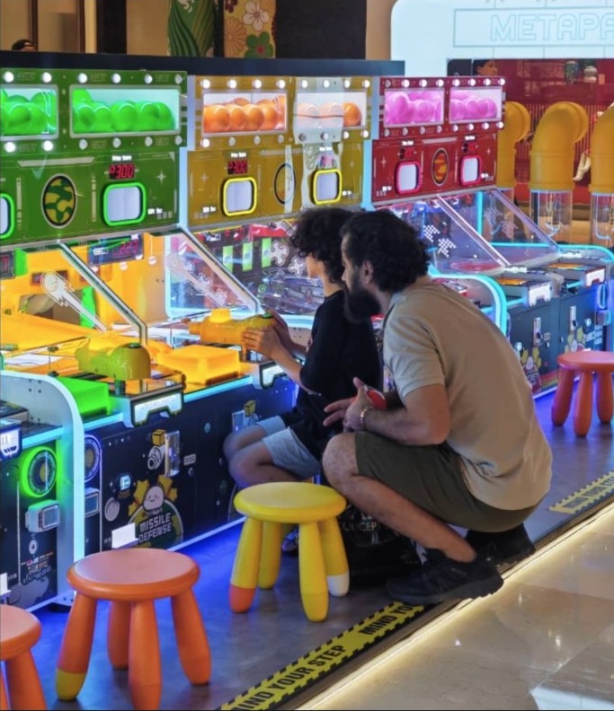 A family enjoying MetaPark skill ball machines